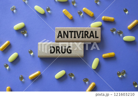 Antiviral Drug symbol. Concept words Antiviral Drug on wooden blocks. Beautiful purple background with pills. Medicine and Antiviral Drug concept. Copy space. 121603210