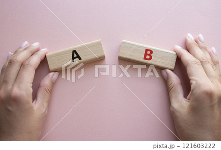 Plan A and Plan B symbol. Concept word Plan A and Plan B on wooden blocks. Businessman hand. Beautiful pink background. Plan A and Plan B concept. Copy space 121603222