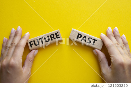 Future or Past symbol. Concept word Future or Past on wooden blocks. Businessman hand. Beautiful yellow background. Business and Future or Past concept. Copy space Future or Past symbol. Concept word Future or Past on wooden blocks. Businessman hand. Beautiful yellow background. Business and Future or Past concept. Copy space 121603230