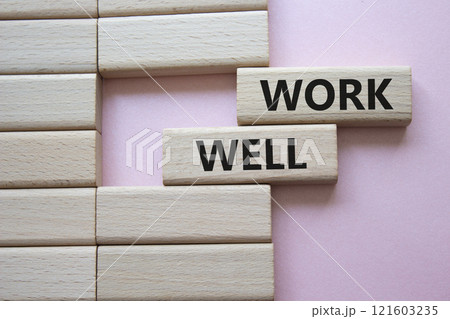 Work Well symbol. Concept word Work Well on wooden blocks. Beautiful pink background. Business and Work Well concept. Copy space 121603235