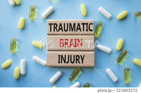 Traumatic Brain Injury symbol. Concept words Traumatic Brain Injury on wooden blocks. Beautiful blue background with pills. Healthcare and Traumatic Brain Injury concept. Copy space. Traumatic Brain Injury symbol. Concept words Traumatic Brain Injury on wooden blocks. Beautiful blue background with pills. Healthcare and Traumatic Brain Injury concept. Copy space. 121603272