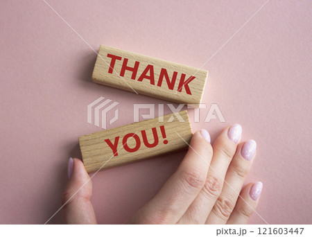 Thank you symbol. Wooden blocks with words Thank you. Businessman hand. Beautiful pink background. Business and Thank you concept. Copy space. 121603447