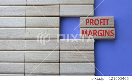 Profit Margins symbol. Concept word Profit Margins on wooden blocks. Beautiful purple background with boat. Business and Profit Margins concept. Copy space 121603466