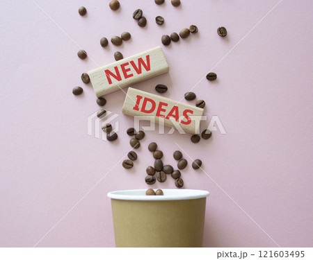 New ideas symbol. Concept word New ideas on wooden blocks. Beautiful pink background with coffee beans and cup. Business and New ideas concept. Copy space 121603495