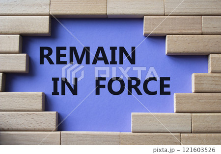 Remain in Force symbol. Concept words Remain in Force on wooden blocks. Beautiful purple background. Business and Remain in Force concept. Copy space 121603526