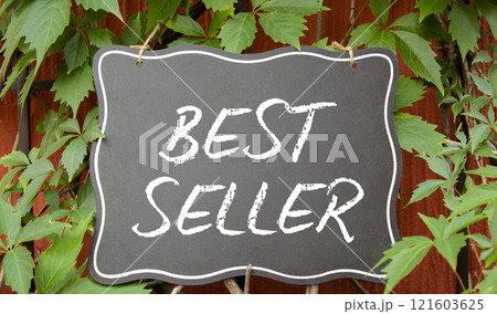 Best Seller symbol. Concept word Best Seller on blackboard. Beautiful red background with plants. Business and Best Seller concept. Copy space Best Seller symbol. Concept word Best Seller on blackboard. Beautiful red background with plants. Business and Best Seller concept. Copy space 121603625