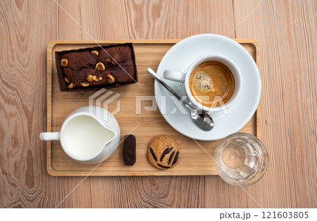 Brownie, coffee cup, mil, water, a coockie and Belgian chocolate serving in Koekelberg, Belgium 121603805