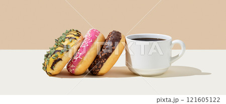 Espresso coffee cup and fresh donuts on beige and white background with shadow. 121605122