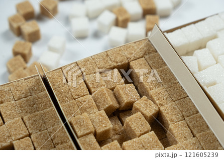 Cubes of demerara cane sugar and white beet sugar top view 121605239