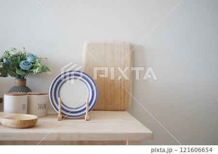 Minimalist Table Display with Blue Striped Plate and Wooden Elements 121606654
