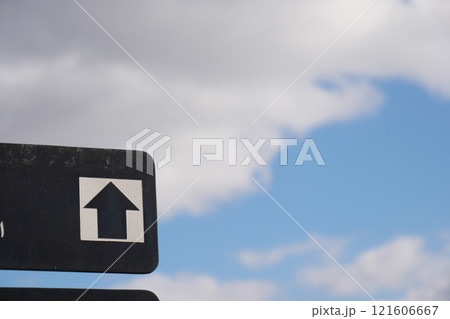 This is a Directional Sign on a Clear Day with Beautiful Clouds Above This is a Directional Sign on a Clear Day with Beautiful Clouds Above 121606667