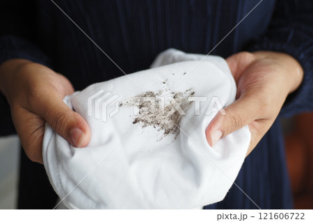 women holding white color dirty shirt, showing making stain 121606722