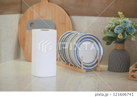 Simple Kitchen Countertop With White Roll, Dish Rack, and Floral Display Simple Kitchen Countertop With White Roll, Dish Rack, and Floral Display 121606741