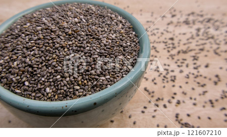 Chia Seeds, Salvia Hispanica, Spanish sage, Salba, Wild sage in a Blue Bowl on Wooden Background Chia Seeds, Salvia Hispanica, Spanish sage, Salba, Wild sage in a Blue Bowl on Wooden Background 121607210