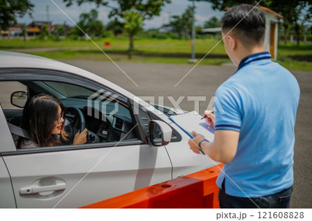 The driving assessment is in progress, evaluating new driver performance 121608828