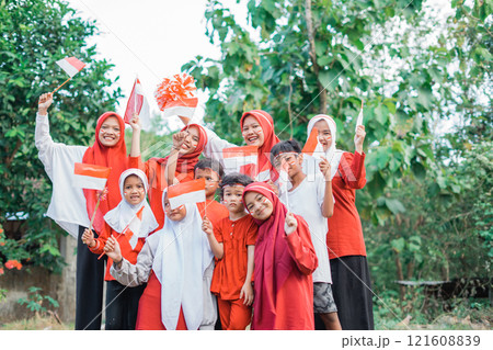 group of young women and men holding small Indonesian flags group of young women and men holding small Indonesian flags 121608839