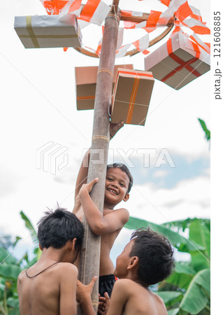 smiling child wins a prize in a pinang climbing competition with friends 121608885
