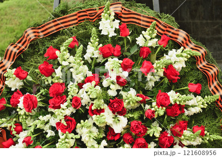 Basket with red rose and lily Saint George ribbon 121608956
