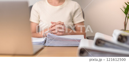Asian woman working with computer laptop, female businesswoman reading report and sign contract with documents folder stack at home or office late night. Overworked, work hard and business concept Asian woman working with computer laptop, female businesswoman reading report and sign contract with documents folder stack at home or office late night. Overworked, work hard and business concept 121612500