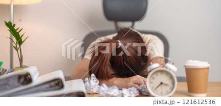 Stressed woman having Tired and Sleepy while working, female businesswoman having headache at office, Exhausted woman with documents folder stack and clock at home late night. Overworked and Overtime Stressed woman having Tired and Sleepy while working, female businesswoman having headache at office, Exhausted woman with documents folder stack and clock at home late night. Overworked and Overtime 121612536