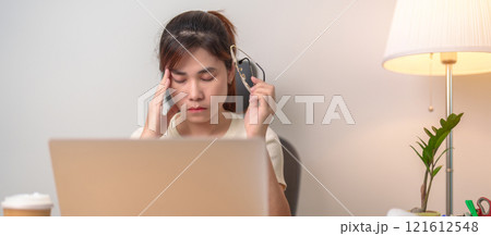 Stressed and Tired Asian woman while working, female businesswoman using laptop with headache, Migraine and Sleepy at office, Exhausted woman with computer at home late night. Overload and Overworked Stressed and Tired Asian woman while working, female businesswoman using laptop with headache, Migraine and Sleepy at office, Exhausted woman with computer at home late night. Overload and Overworked 121612548