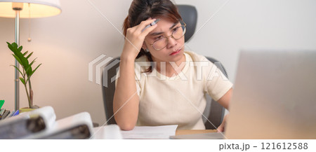 stressed Asian Woman using laptop, Tired female businesswoman working overload with headache and Sleepy at office, Exhausted casual woman with computer at late night in home. Work Life Balance concept stressed Asian Woman using laptop, Tired female businesswoman working overload with headache and Sleepy at office, Exhausted casual woman with computer at late night in home. Work Life Balance concept 121612588
