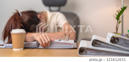 Stressed Asian woman having Tired and Sleepy while working, female businesswoman having headache at office, Exhausted woman with documents folder stack at home late night. Overworked and Overtime Stressed Asian woman having Tired and Sleepy while working, female businesswoman having headache at office, Exhausted woman with documents folder stack at home late night. Overworked and Overtime 121612631