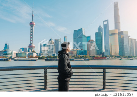 man traveler visiting in Shanghai, China. male Tourist sightseeing Shanghai view of Lujiazui in The Bund of Shanghai. landmark and popular for tourism attractions. Vacation concept 121613057