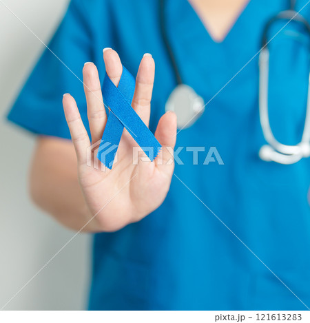 March Colorectal Cancer Awareness month, doctor with dark Blue Ribbon for supporting people living and illness. Healthcare, hope and World cancer day concept 121613283