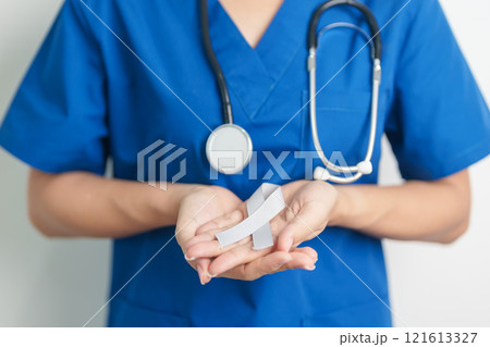 Brain Cancer Awareness May month, Doctor with grey color Ribbon for supporting life people. Healthcare and World cancer day concept Brain Cancer Awareness May month, Doctor with grey color Ribbon for supporting life people. Healthcare and World cancer day concept 121613327