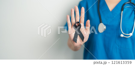 Melanoma and skin cancer, Vaccine injury awareness month and rest in peace concepts. doctor holding black Ribbon Melanoma and skin cancer, Vaccine injury awareness month and rest in peace concepts. doctor holding black Ribbon 121613359
