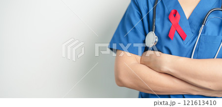 Doctor with Red Ribbon for December World Aids Day, acquired immune deficiency syndrome, multiple myeloma Cancer Awareness month and National Red ribbon week. Healthcare and world cancer day concept 121613410