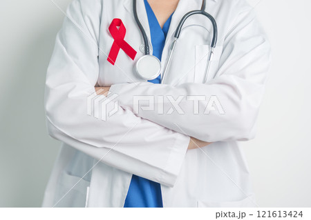 Doctor with Red Ribbon for December World Aids Day, acquired immune deficiency syndrome, multiple myeloma Cancer Awareness month and National Red ribbon week. Healthcare and world cancer day concept 121613424
