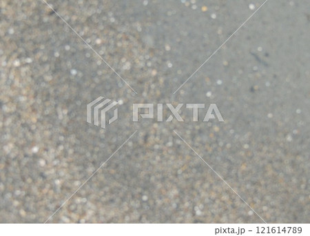 blurred light brownish background of fine textured river or sea wet sand, bokeh with empty copy space with grainy out of focus backdrop 121614789