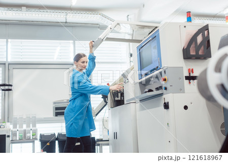 Woman worker at visual inspection of PCB on electronics assembly line Woman worker at visual inspection of PCB on electronics assembly line 121618967