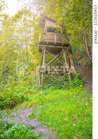 The guard tower stands tall in the labor camp Svornost, surrounded by lush greenery in Jachymov, Czechia. It serves as a historic remnant of the camp's past. The guard tower stands tall in the labor camp Svornost, surrounded by lush greenery in Jachymov, Czechia. It serves as a historic remnant of the camp's past. 121620453