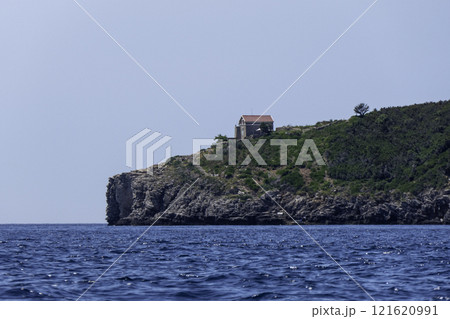 Montenegro, Budva, Sveti Nikola Island with building of small lighthouse on the Adriatic Sea 121620991