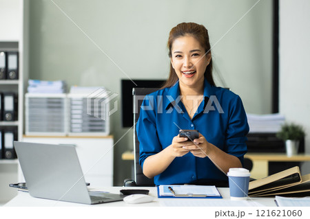 Portrait of a successful business woman using smartphone. Portrait of a successful business woman using smartphone. 121621060