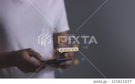 Young Man hand using smartphone mobile with five star to review and give 5 stars  121621837