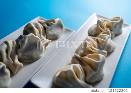 traditional georgian khinkali dumplings with cheese or meat on blue background traditional georgian khinkali dumplings with cheese or meat on blue background 121622202