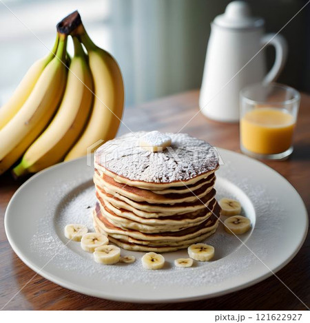 Sunlit Delights: Banana Pancakes on a White Plate 121622927