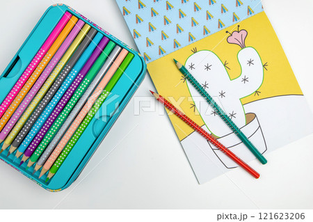 Colored pencils for drawing various colors and coloring book for children. 121623206