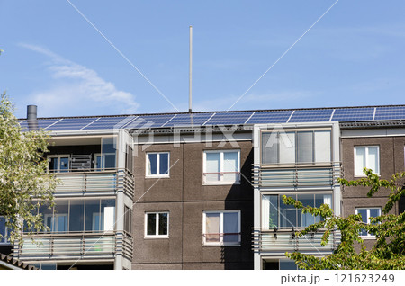 Residential building with new roof and solar panels. 121623249