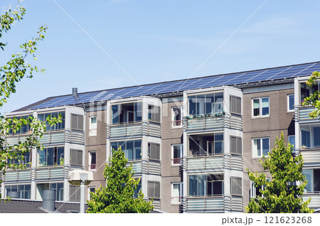 Residential building with new roof and solar panels. 121623268