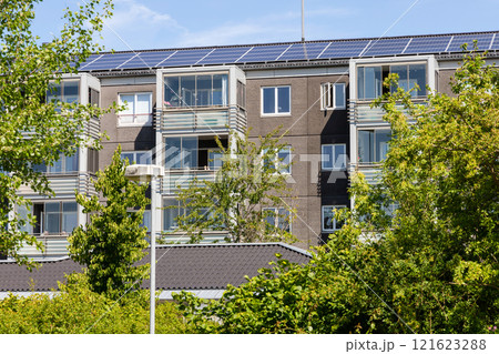 Residential building with new roof and solar panels. Residential building with new roof and solar panels. 121623288