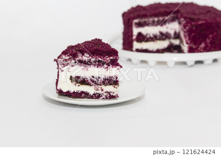 Red Velvet Cake is a traditional red chocolate cake with white buttercream on white background 121624424