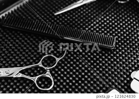 Professional hairdressing tools arranged neatly on a styling workstation 121624830