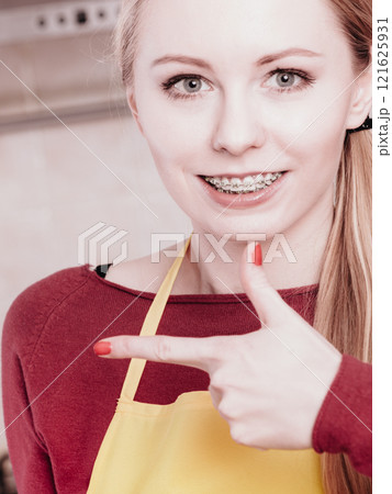 Happy smiling blonde woman having braces 121625931