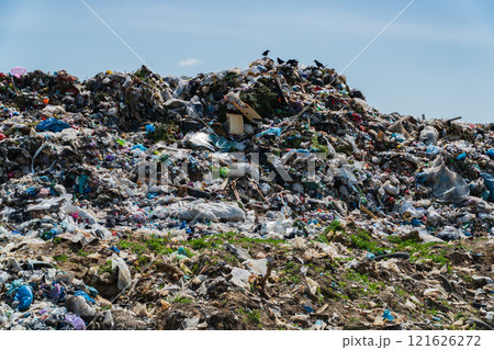 A vast landfill filled with heaps of garbage, including plastic and organic debris, illustrates the ongoing environmental impact of poor waste management practices 121626272
