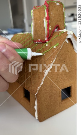Crafting a Gingerbread House with Colorful Icing and Festive Decorations Crafting a Gingerbread House with Colorful Icing and Festive Decorations 121626638